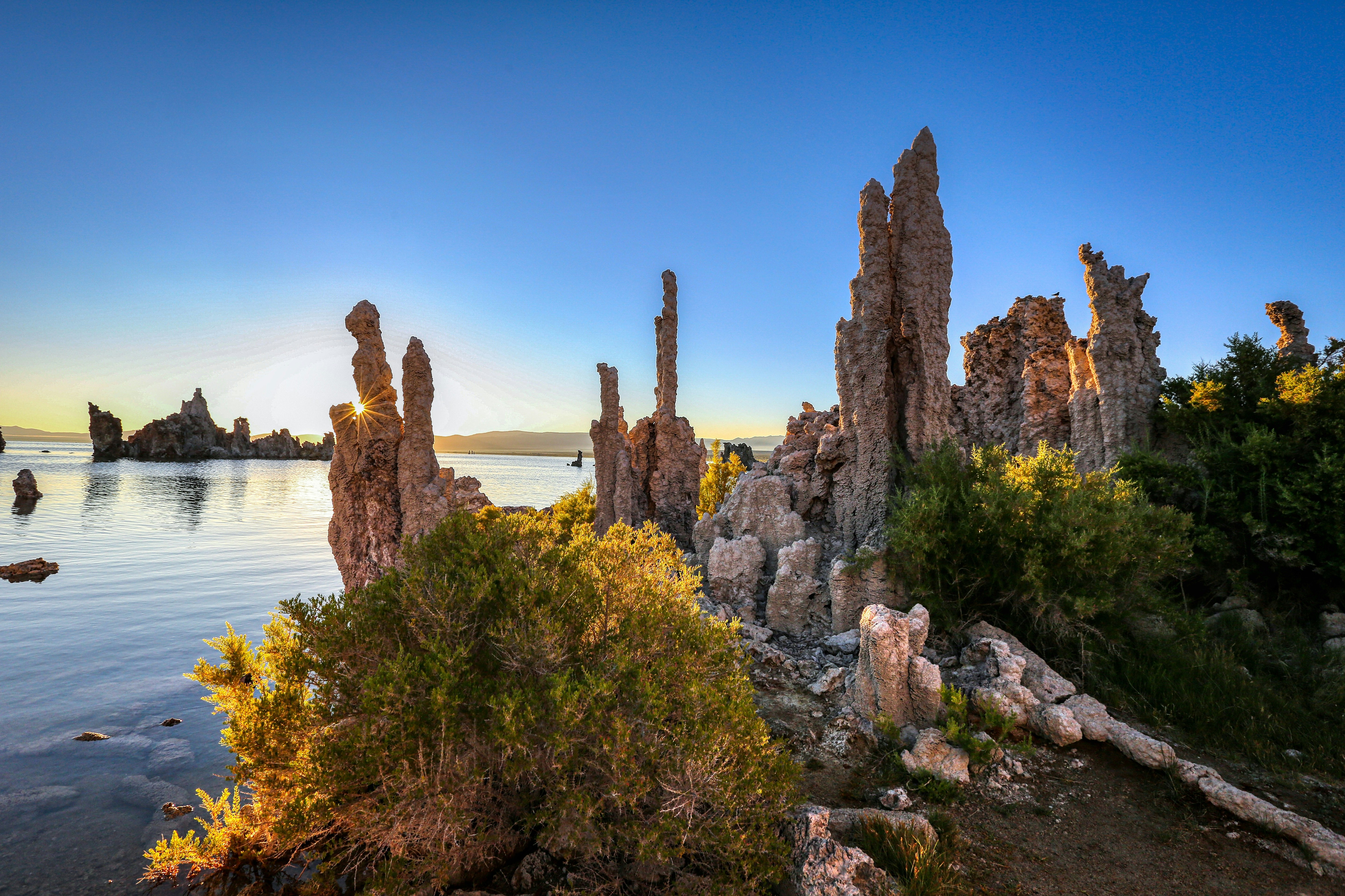 brown rock formation near body of water during daytime